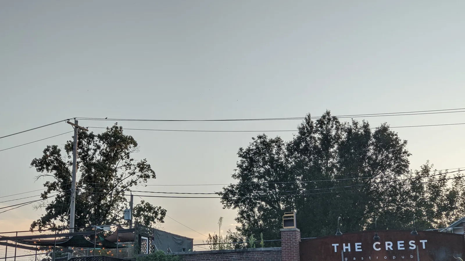Sun setting behind a building