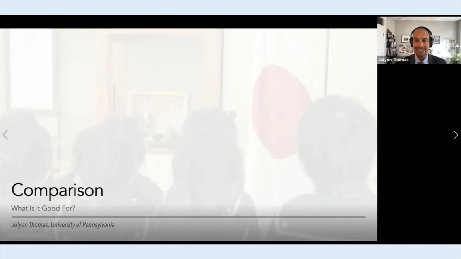Two rectangles between two lighter blue horizontal lines; the larger of the two contains a faded image with four kids looking at a picture and flag of Japan, with the foreground title reading "Comparison: What Is It Good For?" and Jolyon Thomas, University of Pennsylvania. In the upper right corner is an image of Jolyon wearing headphones.