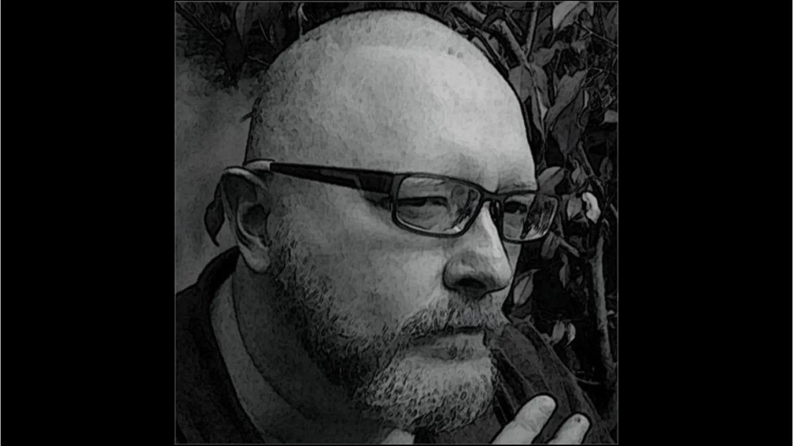 A black and white photo of Eric wearing glasses