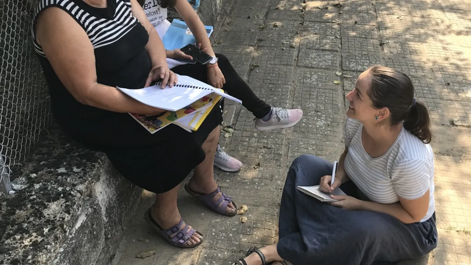 Three people sitting and talking
