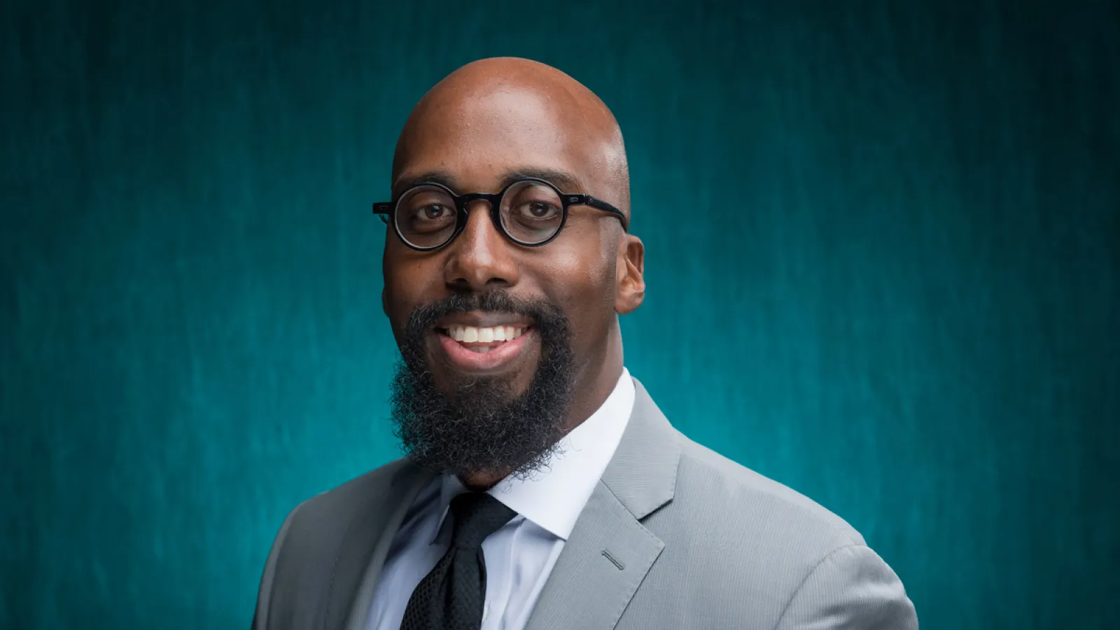 Image of Seth Gaiters with glasses and black tie