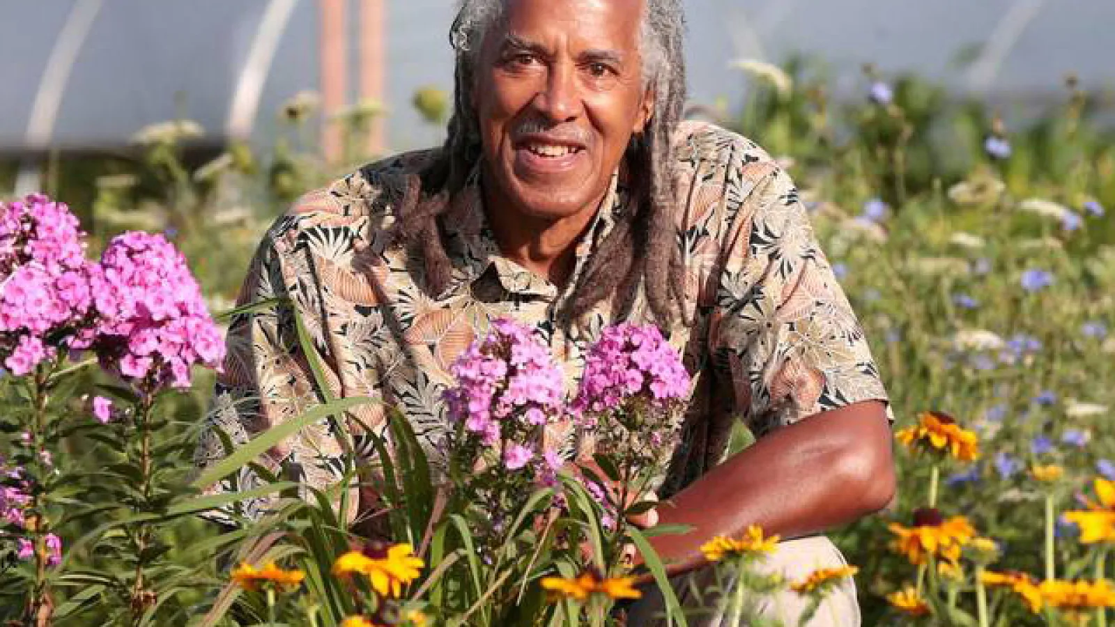 photo of Jim with flowers in foreground