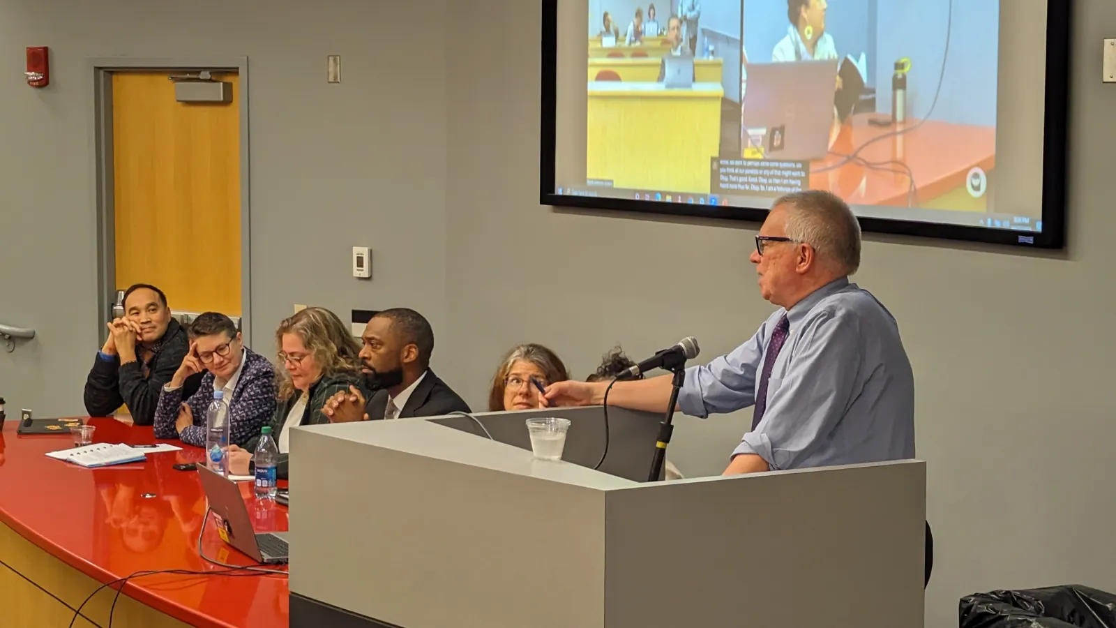 David addressing panelists