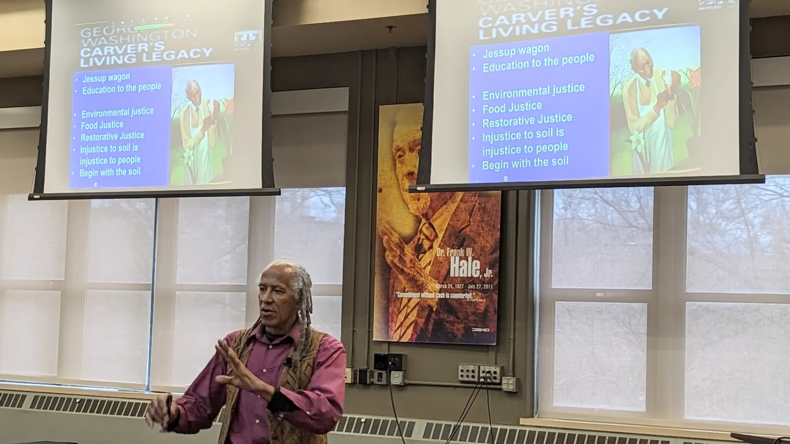 Jim Embry speaking with image of George Washington Carver on projector screen