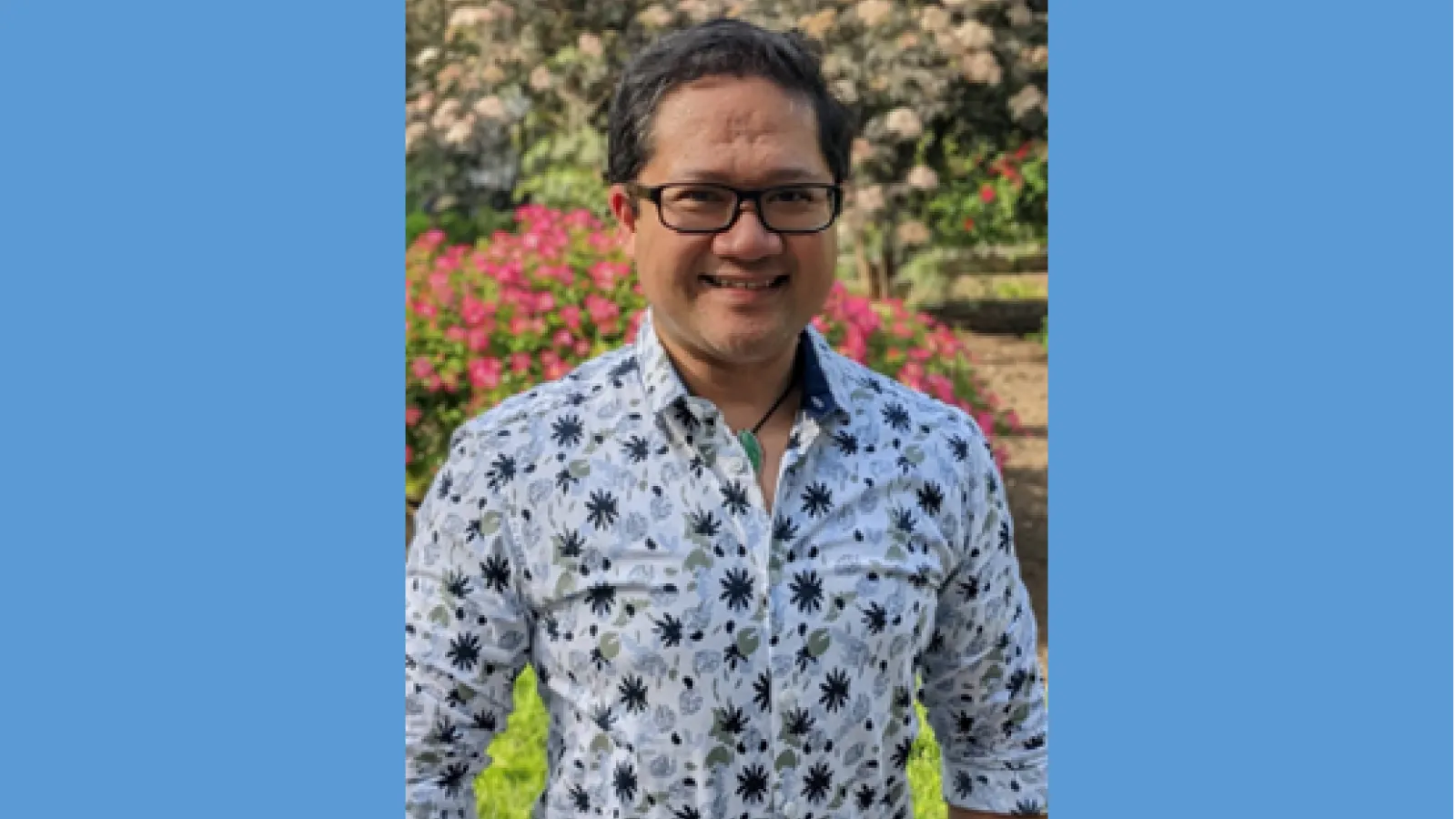 Mark Anthony wearing glasses and floral print
