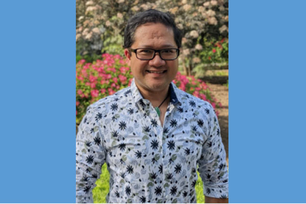 Mark Anthony wearing glasses and floral print