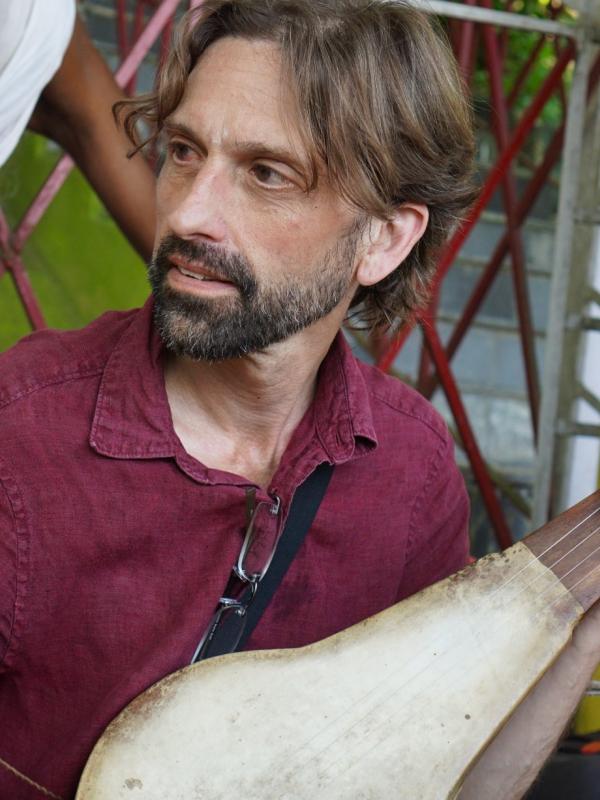 Hugh Urban playing dotara (Indian instrument)