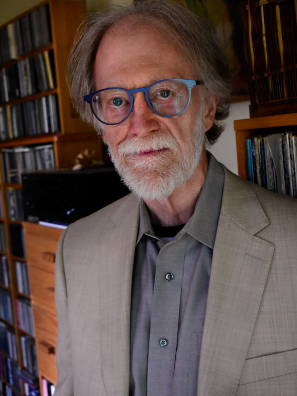 Barry Shank stands in front of his records