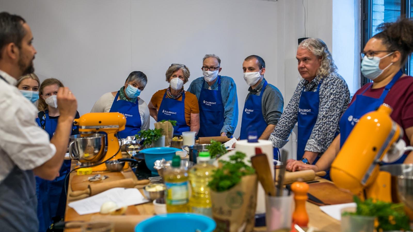 People looking at the cooking instructor