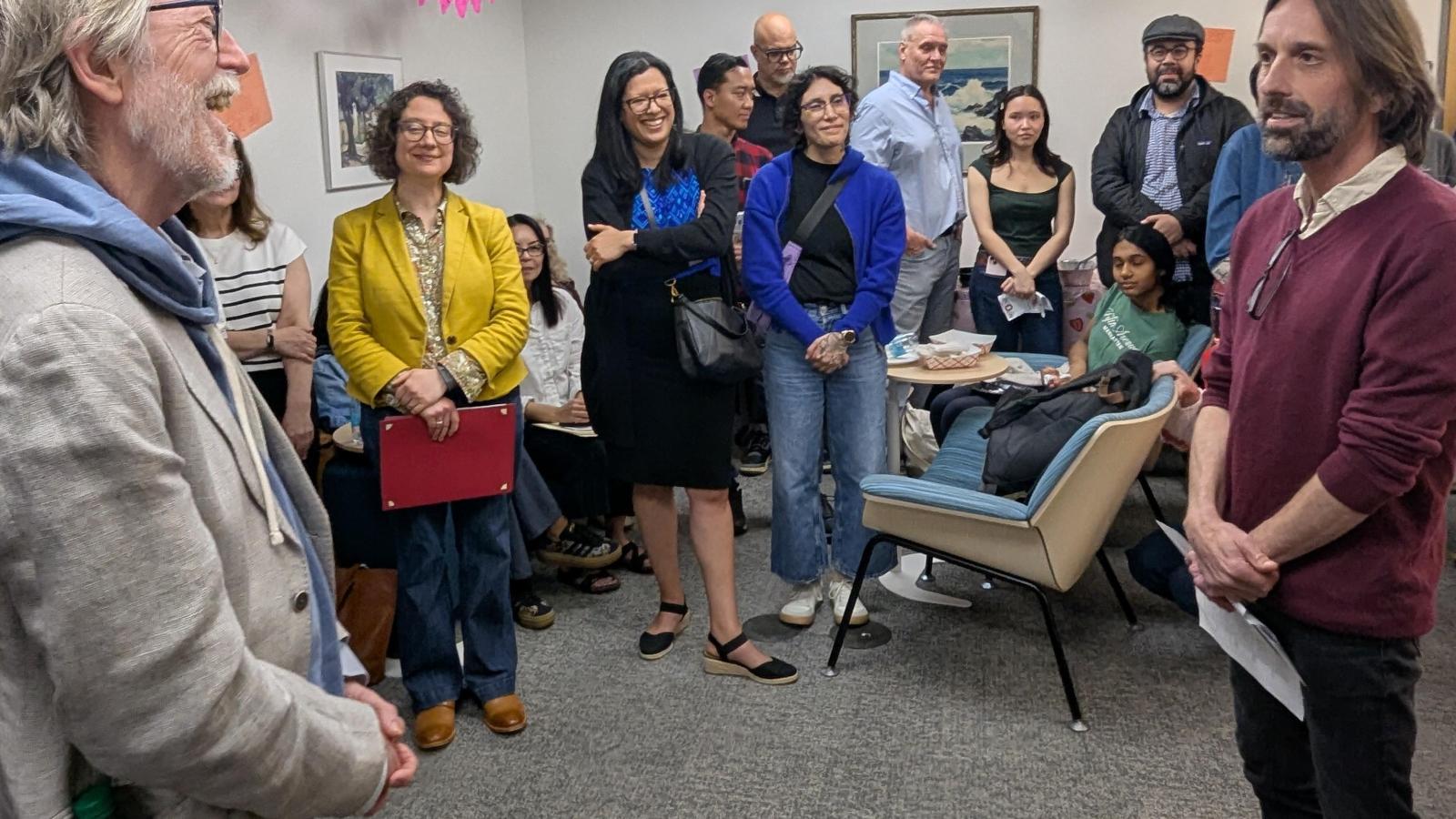 Barry Shank and Hugh Urban in foreground, with Hugh talking about Barry's contributions to the Department