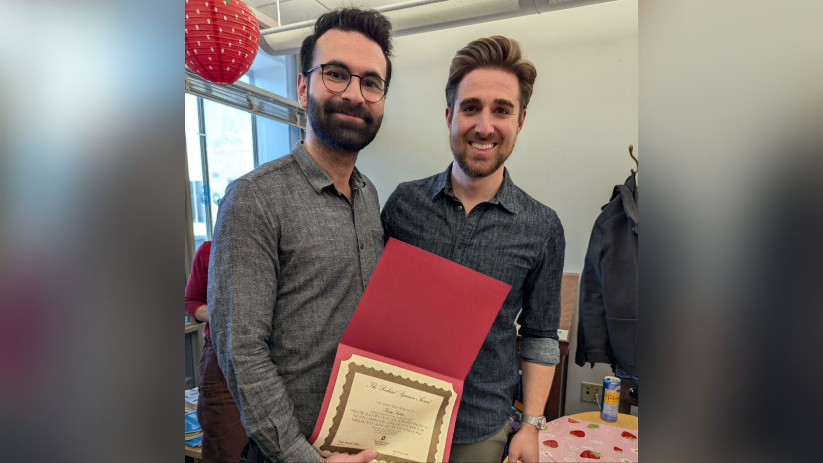 Koray (left) shows the award he received