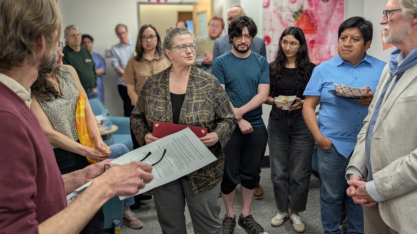 Sue (center) address those present